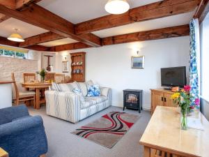 a living room with a couch and a fireplace at Tuckenhay, Mill Spring - Fmf in Ashsprington +37 photos