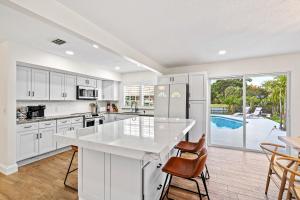 a kitchen with white cabinets and a white counter top at Waterfront Oasis, Heated Pool, MiniGolf, TikiHut in Lake Clarke Shores