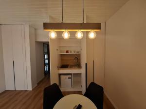 a dining room with a table and a light fixture at Villa White Lake - Ohrid Center Lakeside Accommodation in Ohrid