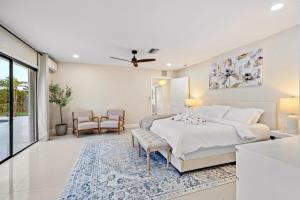 a bedroom with a bed and a living room at Waterfront Oasis, Heated Pool, MiniGolf, TikiHut in Lake Clarke Shores +65 photos