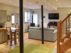a living room with a couch and a table at Barn End in Pooley Bridge