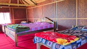 a bedroom with two beds in a room at Nature's Harmony Heaven Resort in Dāmbuk +21 photos