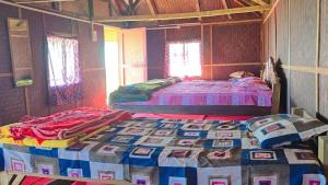 a bedroom with two beds in a room at Nature's Harmony Heaven Resort in Dāmbuk