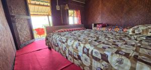 a bedroom with a large bed in a room at Nature's Harmony Heaven Resort in Dāmbuk
