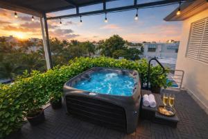 a hot tub on a balcony with a sunset at Ocean Park 3BDR 2b Hot tub-Terrace Riviera Villa in San Juan