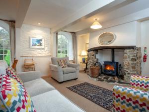 a living room with a couch and a fireplace at Tuckenhay, Clock Tower Cottage - Fjg in Ashsprington +42 photos