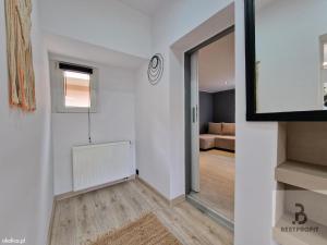 a hallway with a mirror and a living room at Atlantis villa in Ustka