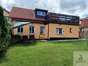 a house with a table and chairs in a yard at Atlantis villa in Ustka