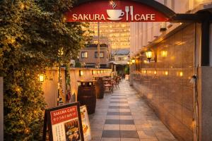 a restaurant with a sign that reads sakaicaica on a sidewalk at Sakura Hotel Hatagaya in Tokyo