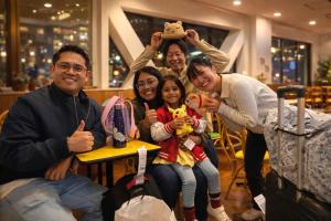a group of people are posing for a picture at Sakura Hotel Hatagaya in Tokyo