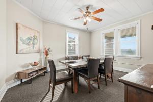 a dining room with a table and chairs and a ceiling fan at Spacious & Clean 3BR 2 Balconies Parking in Pittsburgh