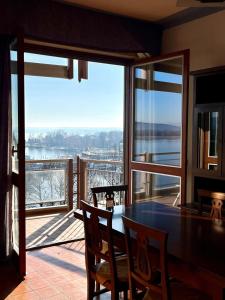 a dining room with a table and a view of the water at Gemelli al Lago in Arona