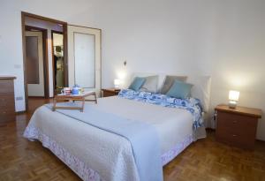 a bedroom with a large white bed with blue pillows at Gemelli al Lago in Arona