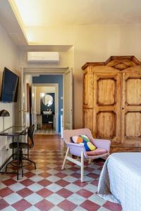 a bedroom with a bed and a chair and a table at Luna Nova in Meina