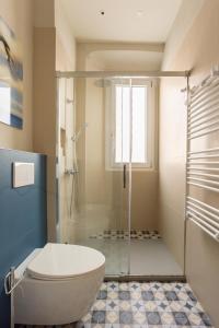 a bathroom with a toilet and a glass shower at Luna Nova in Meina +21 photos