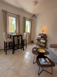 a living room with two tables and a couch at La Fontaine du Soleil in Salernes