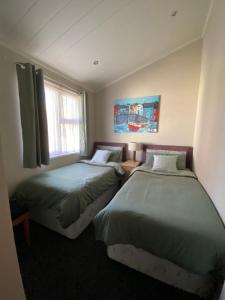 a bedroom with two beds and a window at Sunset Lodge in Poole +22 photos