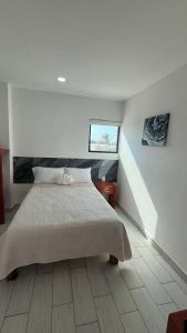 a bedroom with a large bed and a staircase at Hotel Las Arenitas in Mazatlán
