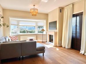 a living room with a couch and a fireplace at Villa Verano in Noordwijk aan Zee