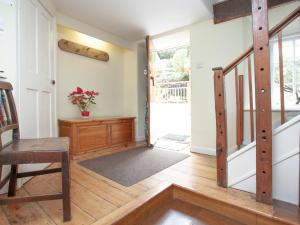 a living room with a wooden floor and a door at Tuckenhay, 2 Salle Cottage - Fcr in Ashsprington +40 photos