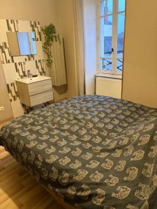 a bedroom with a bed and a sink and a window at Rodrigue in Saint-Pierre-le-Moûtier