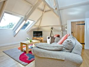 a living room with a couch and a table at Tuckenhay, Coomberry Loft - Fcp in Ashsprington