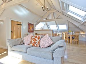 a living room with a couch and a dining room at Tuckenhay, Coomberry Loft - Fcp in Ashsprington