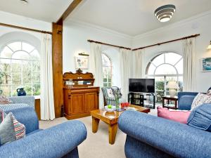 a living room with two blue couches and a tv at Tuckenhay, Papermaker's - Fke in Ashsprington +39 photos