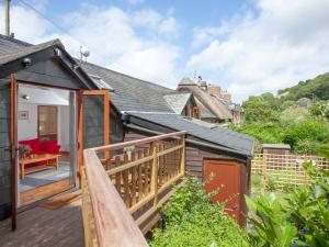 a house with a wooden deck and a balcony at Mill Bank No 8 - Uk33902 in Ashsprington