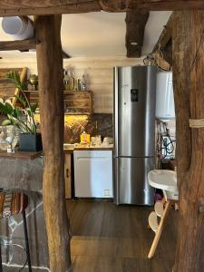 a kitchen with a stainless steel refrigerator at Хатка у долині in Kosiv