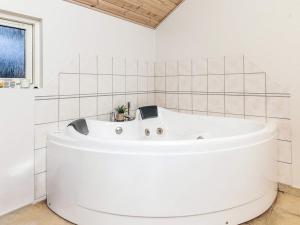 a large white bath tub in a white bathroom at Luxury Retreat by Kramnitze in Rødby +22 photos
