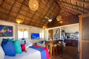 a bedroom with a bed and a dining room at Casa Catalina - Tropical Escape in Puerto Morelos