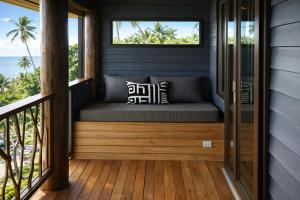 a bed on the porch of a tiny house at Luxury Ocean View Villa, Savusavu Bay, Blue Bayou Bure with Starlink in Savusavu +5 photos