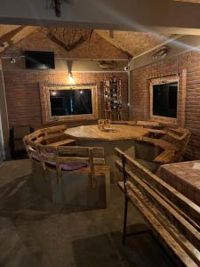 a room with a bar with benches and a sink at Household Grbovic in Bijelo Polje