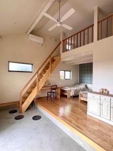 a large room with a staircase and a living room at yucurum in Itoman