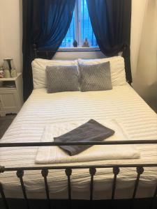 a bed with a black frame and pillows on it at Abbey Meadows View ABB in Redditch
