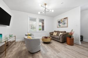 a living room with a couch and a table at Bright & Clean 2BR Near Downtown Porch Parking in Pittsburgh