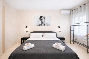 a bedroom with a bed with two towels on it at Appio Rooms Haven in Rome