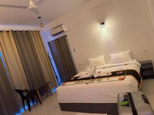 a bedroom with a large bed in a room at REEF SHINE Thoddoo in Thoddoo +70 photos