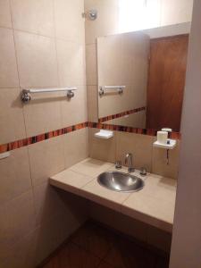 a bathroom with a sink and a mirror at Cabaña la Gabita in Villa Ciudad Parque +25 photos