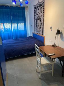 a bedroom with a bed and a desk and a table at Villa Marine Plus in Fontane Bianche