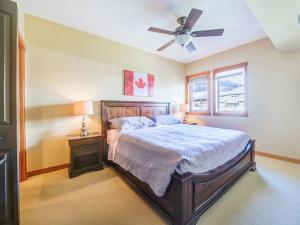 a bedroom with a bed and a ceiling fan at Top Floor Beautiful Mountain Views! 2 Bed 2 Bath in Canmore