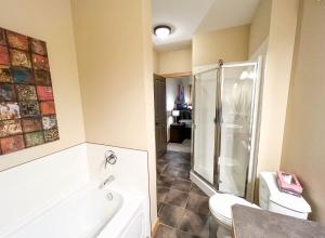 a bathroom with a shower and a toilet and a sink at Top Floor Beautiful Mountain Views! 2 Bed 2 Bath in Canmore