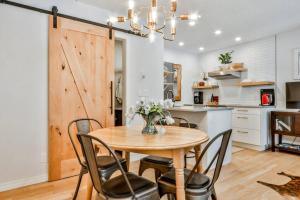 a dining room with a wooden table and chairs at A Rustic Modern Mountain Condo - 2 bed, 2-Level in Canmore