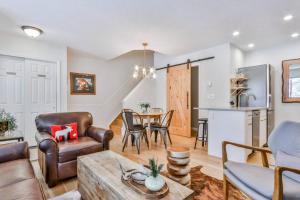 a living room with a couch and a table at A Rustic Modern Mountain Condo - 2 bed, 2-Level in Canmore