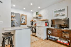 a kitchen with white walls and a counter and a sink at A Rustic Modern Mountain Condo - 2 bed, 2-Level in Canmore +16 photos