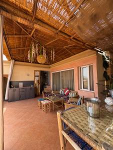 a large living room with a table and chairs at Maison Mamdy Triplex & Rooftop in Marrakesh