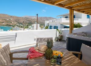 a table with a pineapple on top of a balcony at Le Reve in Aegiali