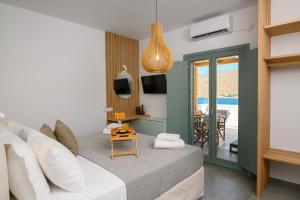 a living room with a bed and a dining room at Le Reve in Aegiali