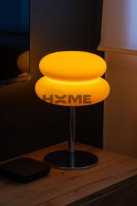 a yellow lamp sitting on top of a wooden table at Vanderburch 70's in Cambrai